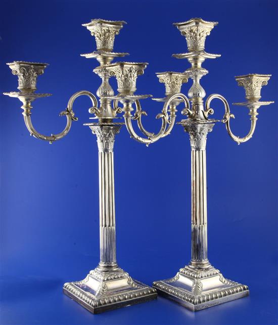 A pair of silver plated corinthian column two branch three-light candelabra, 19in.